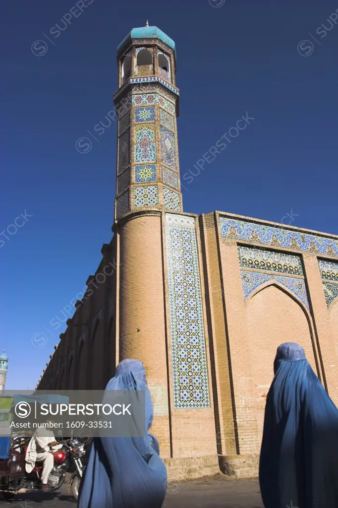 Afghanistan, Herat, Ladies wearing blue burqa walking past the Friday Mosque or Masjet-eJam