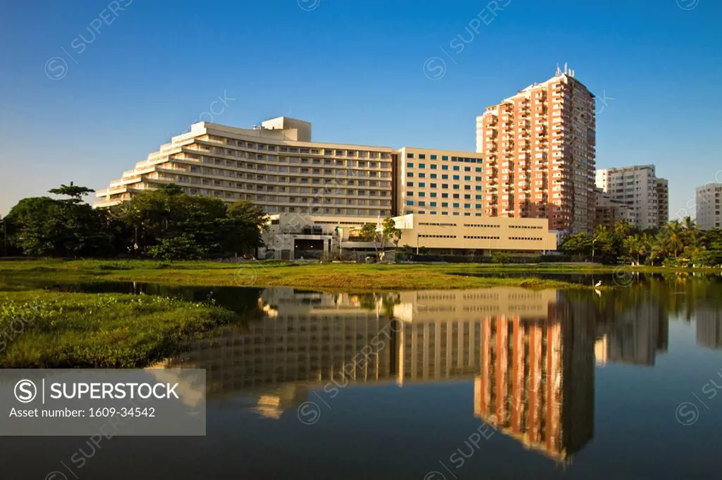 Colombia, Bolivar, Cartagena De Indias, Bocogrande, El Laguit, Hilton Hotel reflecting in lagoon at dawn