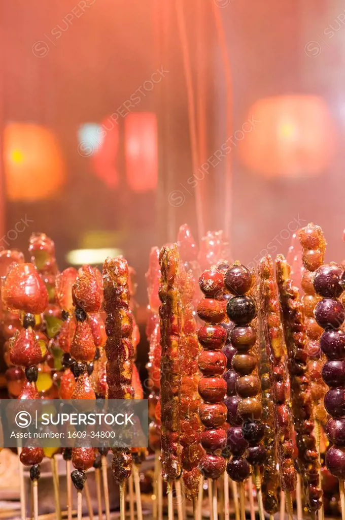 China, Heilongjiang, Harbin, Frozen Haw berries on a stick _ popular Chinese winter snack