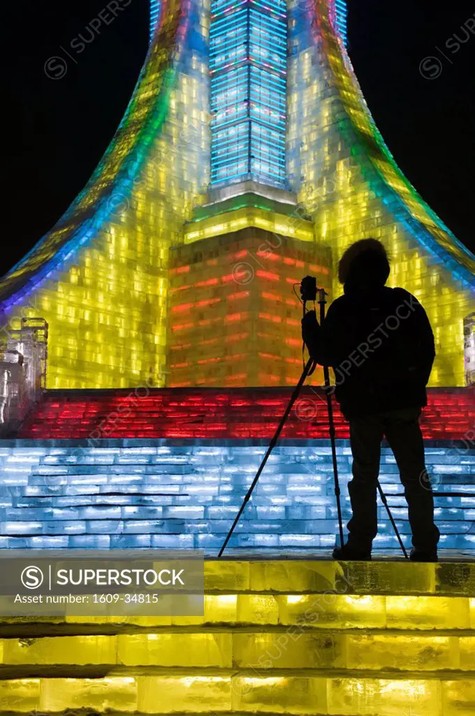 China, Heilongjiang, Harbin, Ice and Snow Festival, Photographer Silhouette at Ice Olympic Tower