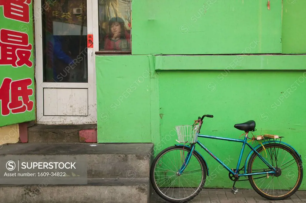 China, Heilongjiang, Harbin, Jingwei Jie Street, Bicycle outside Cafe & young Chinese Girl