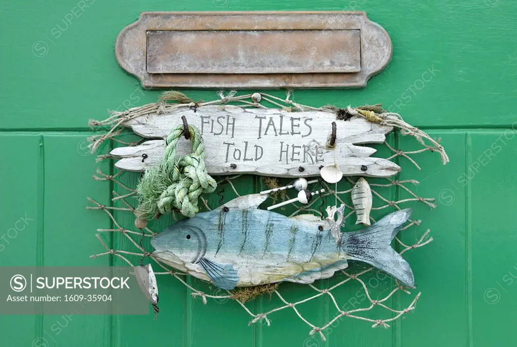 Fish Tales Told Here sign on the cottage door, Clovelly, Devon, UK