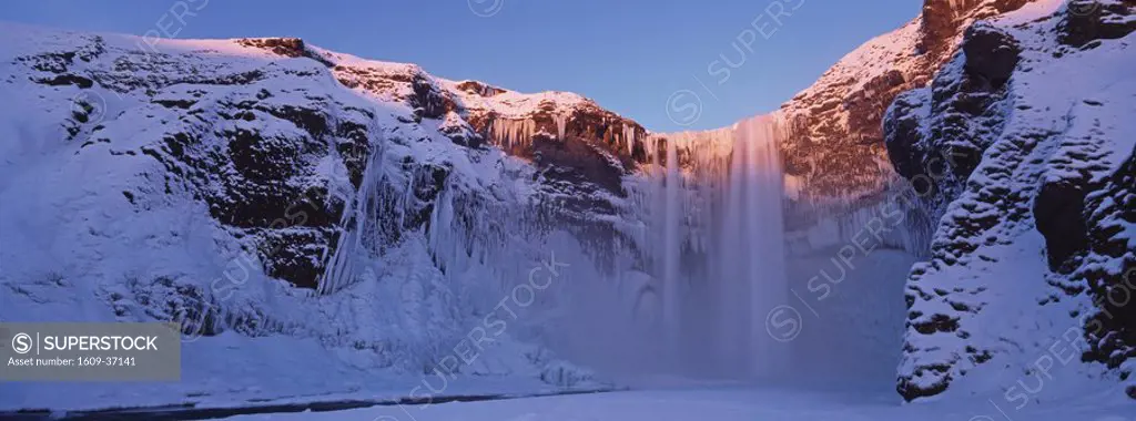 Iceland, Skogar, Skogafoss, Skogafoss waterfall surrounded by snow and ice in winter