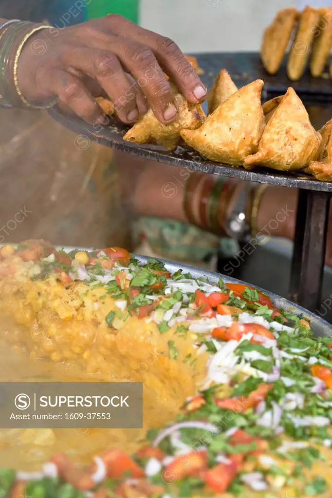India, West Bengal, Darjeeling, Market, Woman arranging freshly cooked samosas