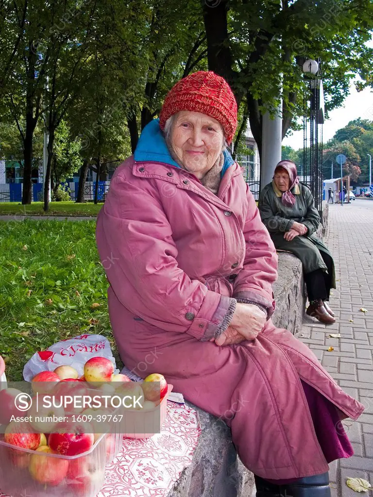 Russia, Kaliningrad, Elderly woman selling apples on Prospekt Mira