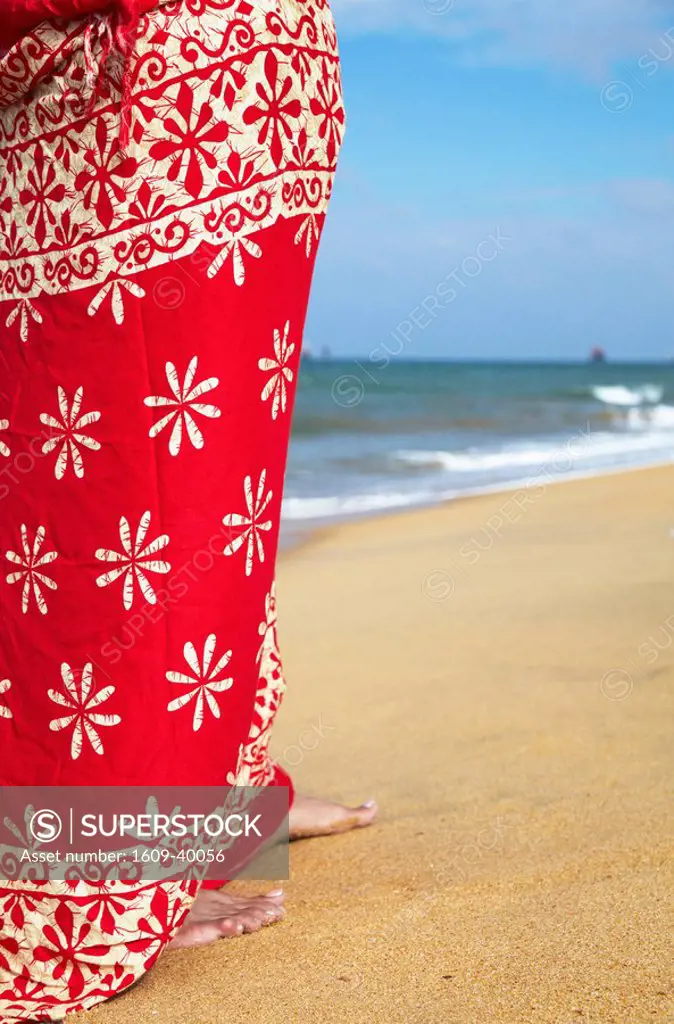 Woman standing on beach, Negombo, Sri Lanka MR