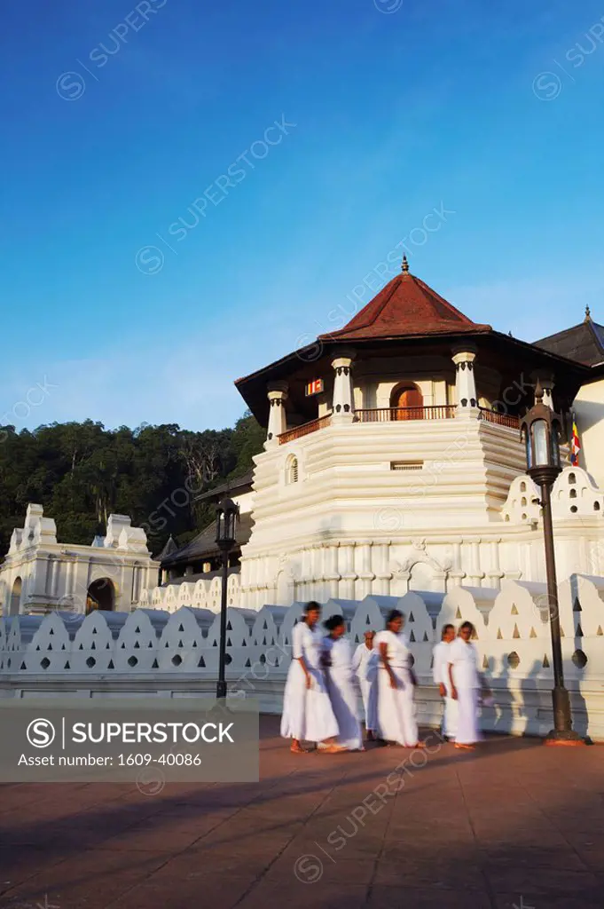 Women walking past Temple of the Tooth Sri Dalada Maligawa, Kandy, Sri Lanka