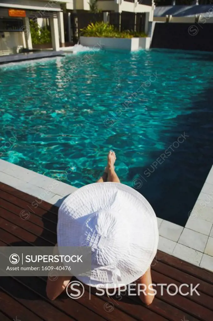 Woman relaxing by pool in Bhu Nga Thani Resort and Spa, Railay, Krabi Province, Thailand MR