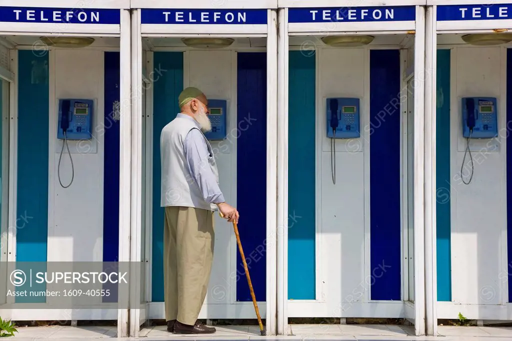 Muslim man in phone box, Istanbul, Turkey