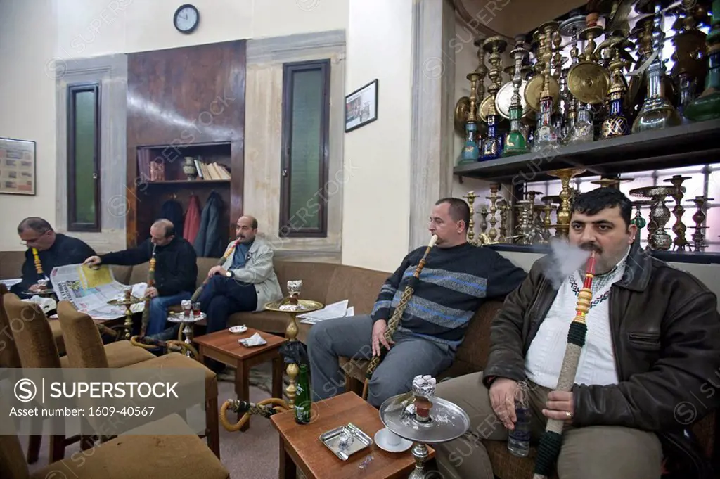 Turksish men smoking thier Nargiles Bubble Pipes. Corlulu Ali Pasha Cafe, Istanbul, Turkey. PR