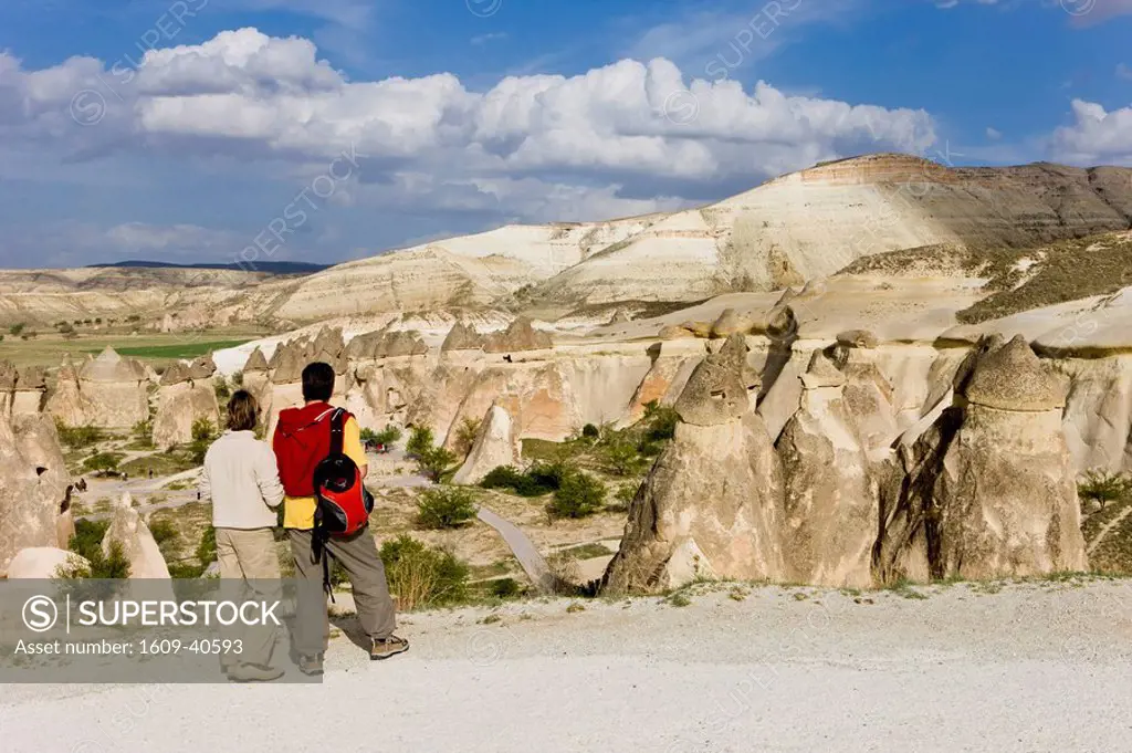 Tourists looking over Volcanic tufa formations, Fairy Chimneys, Pasabag, near Zelve, Cappadocia, Turkey