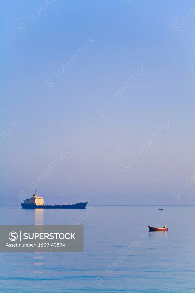 Turkey, Trabzon, Fishing boat and container ship in Black sea