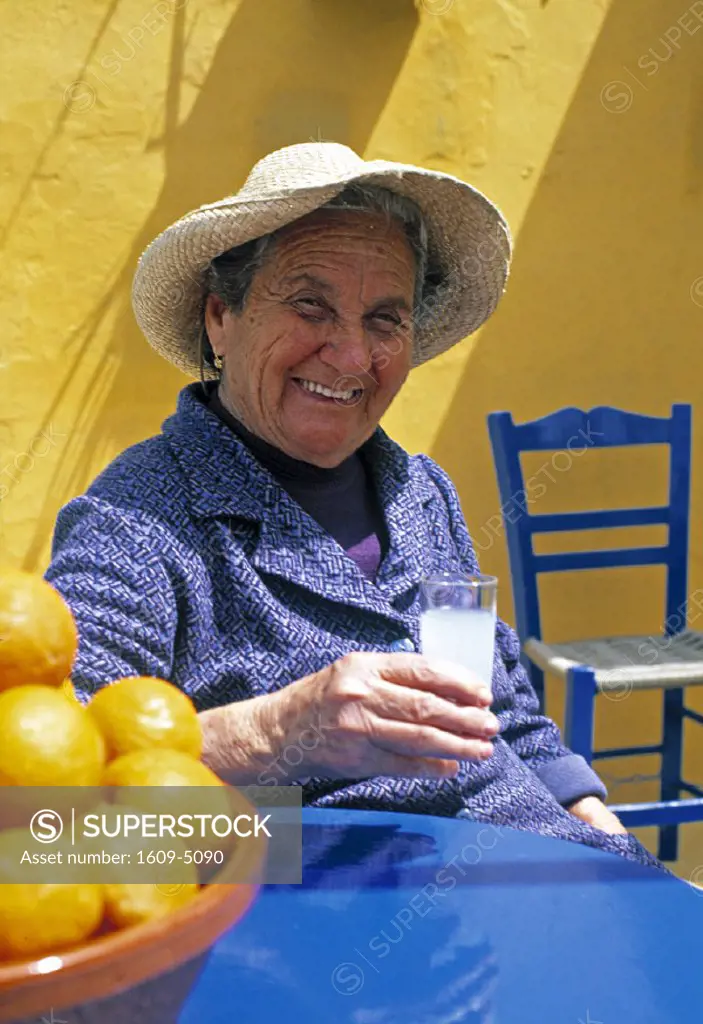 Woman drinking Ouzo, Crete, Greece