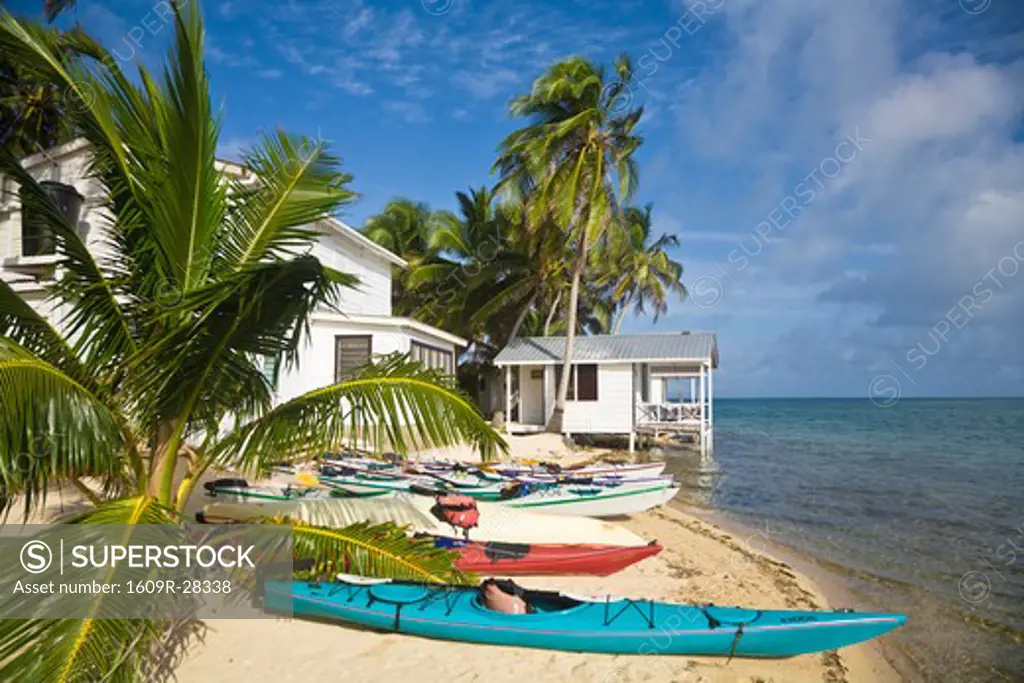Belize, Tobaco Caye, Kayaks on beach by hotel cabanas