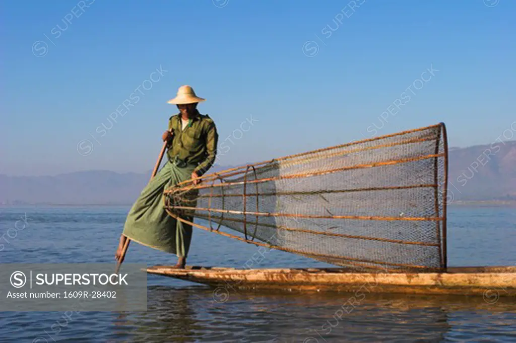 Myanmar (Burma), Shan State, Inle Lake, Intha man fishing with cone shaped net