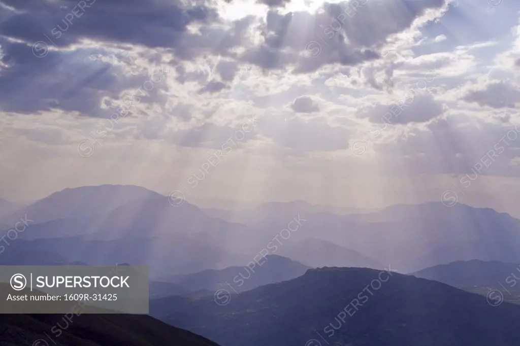 Turkey, Eastern Turkey, Nemrut Dagi National Park, Suns rays shining through clouds over mountains