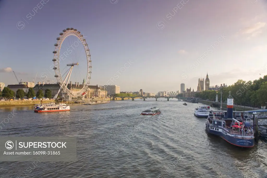 England, London, People having drink on river boat/restaurant  &Houses of Parliment  & Millennium Wheel