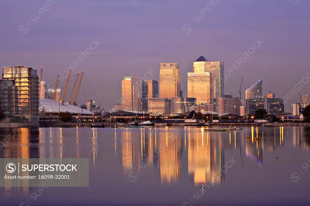 England, London, Newham,  Royal Victoria Docks, Canary Wharf buildings and O2 Arena at dawn