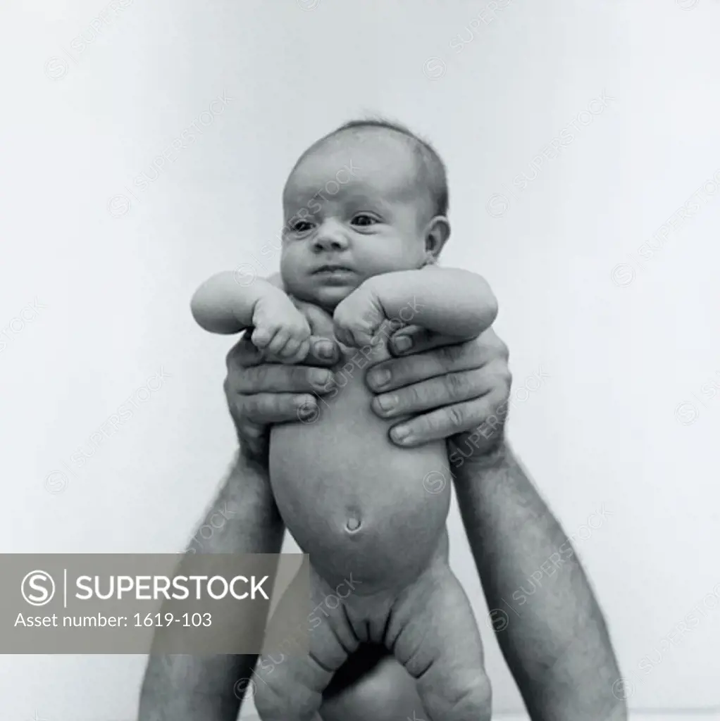 Close-up of a man holding his daughter up