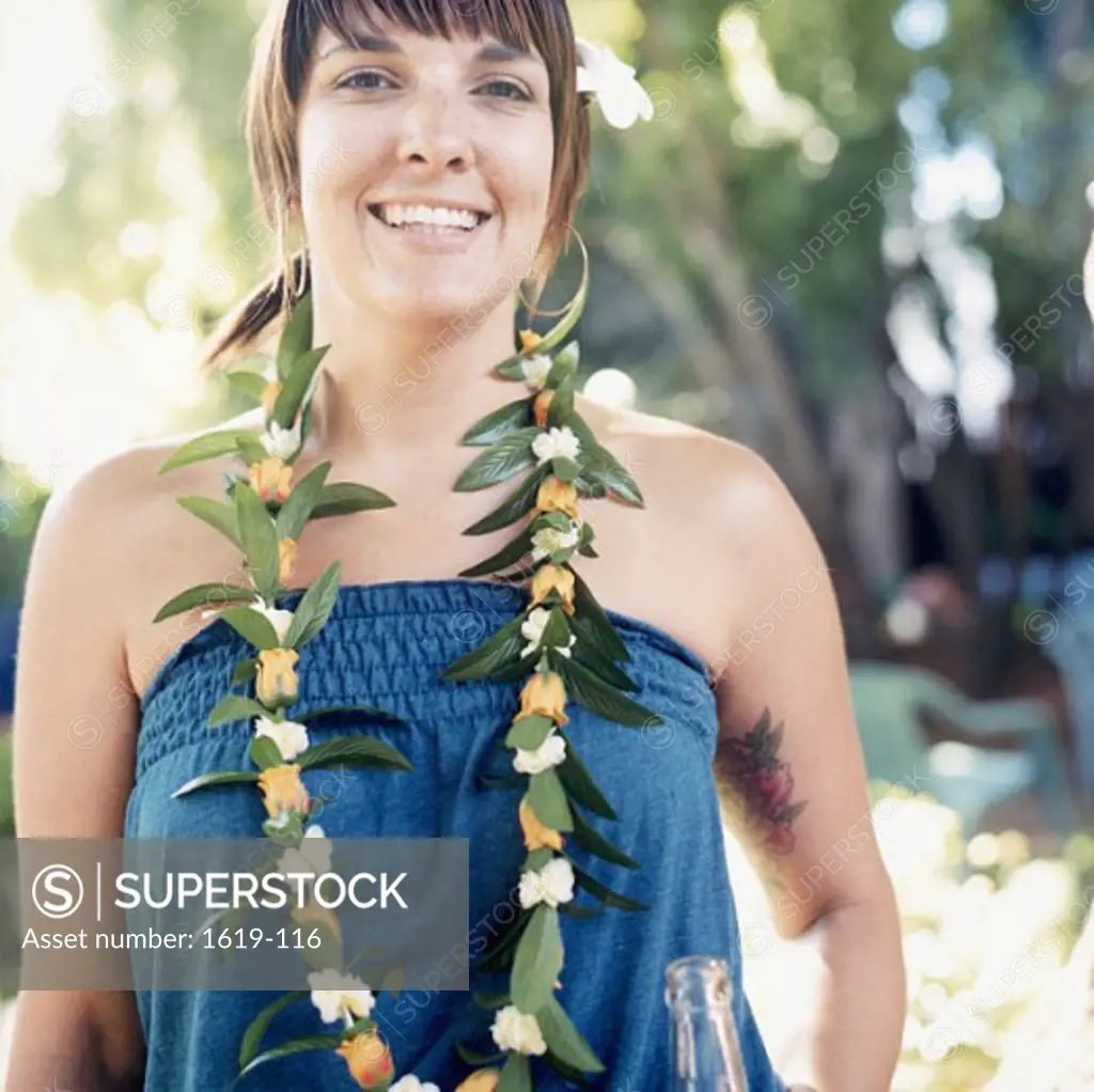 Portrait of a young woman wearing a lei and smiling