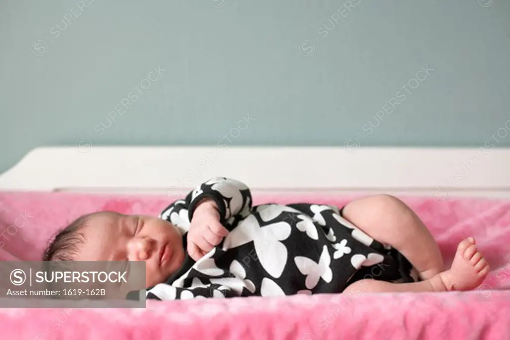 Baby girl sleeping in a crib