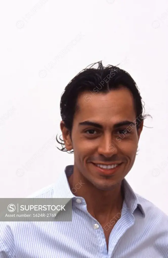 An attractive Hispanic male being happy.