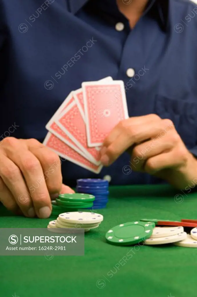 Portrait of a man's hands playing poker.