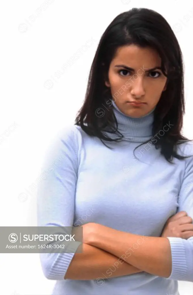 Hispanic woman annoyed in a blue turtleneck.