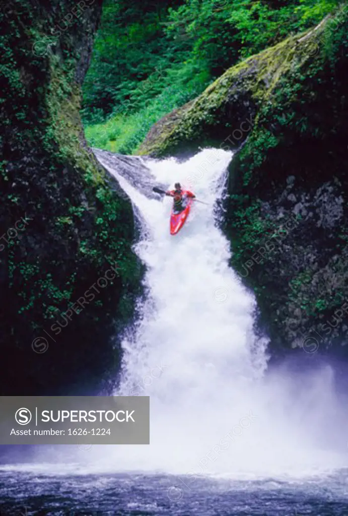 Kayaker over Waterfall