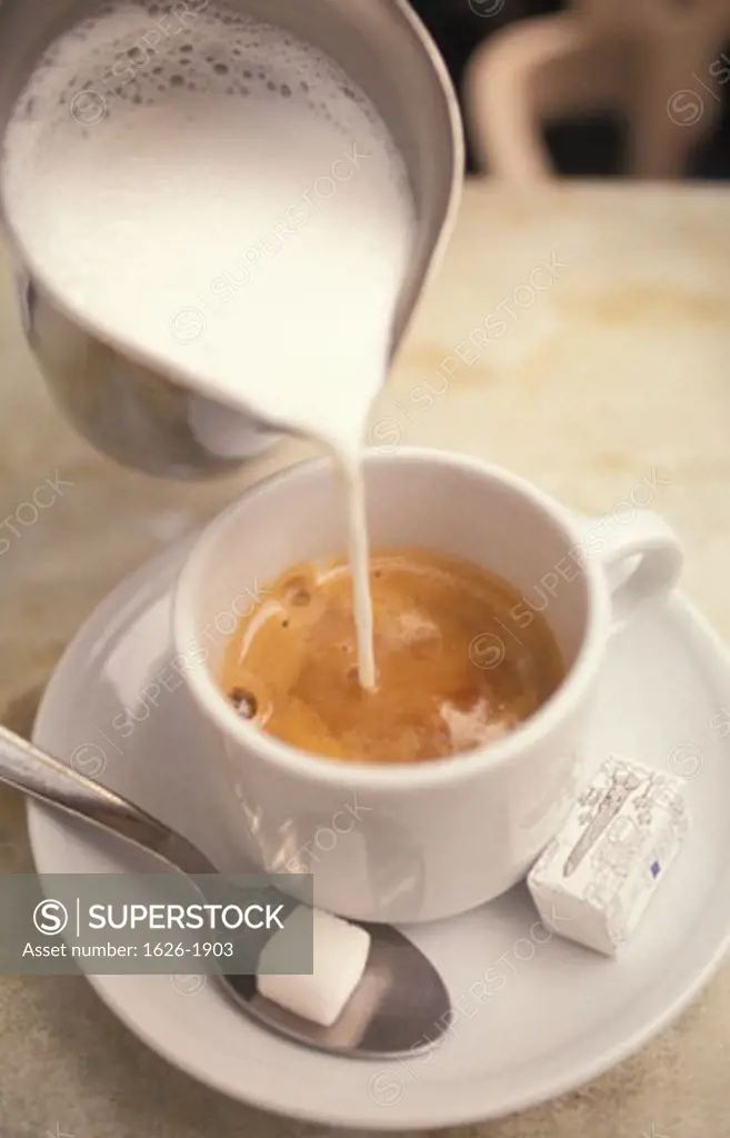 Pouring Steamed Milk into Espresso