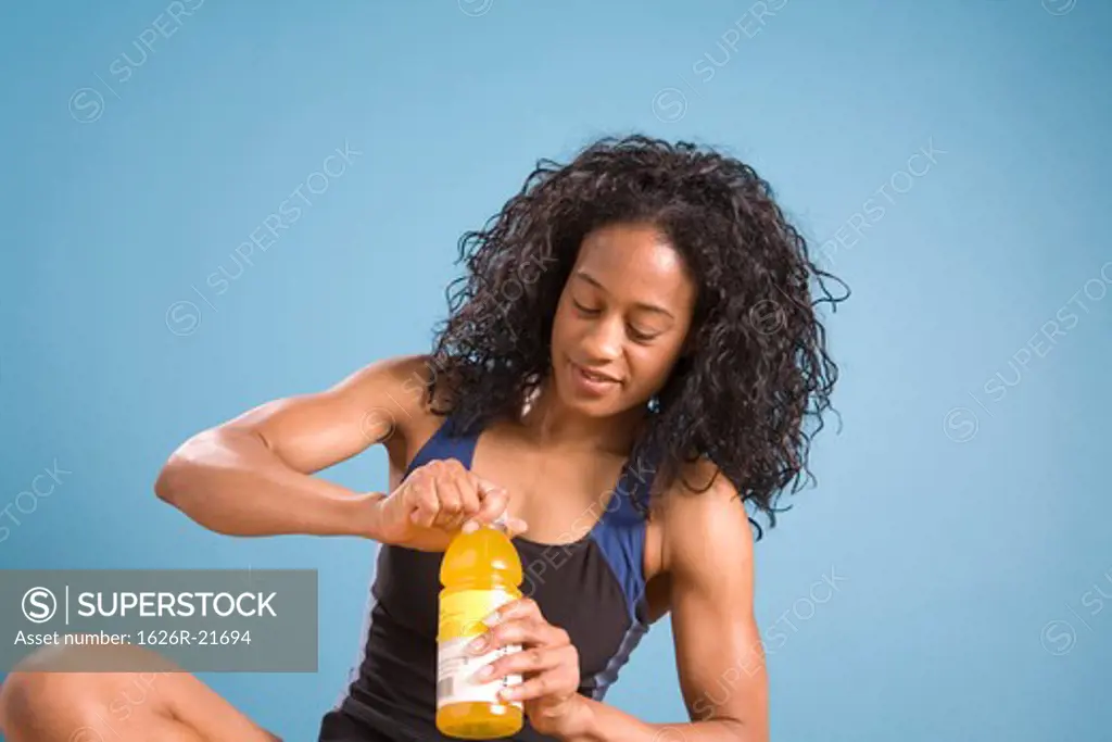 Woman Opening Juice Bottle