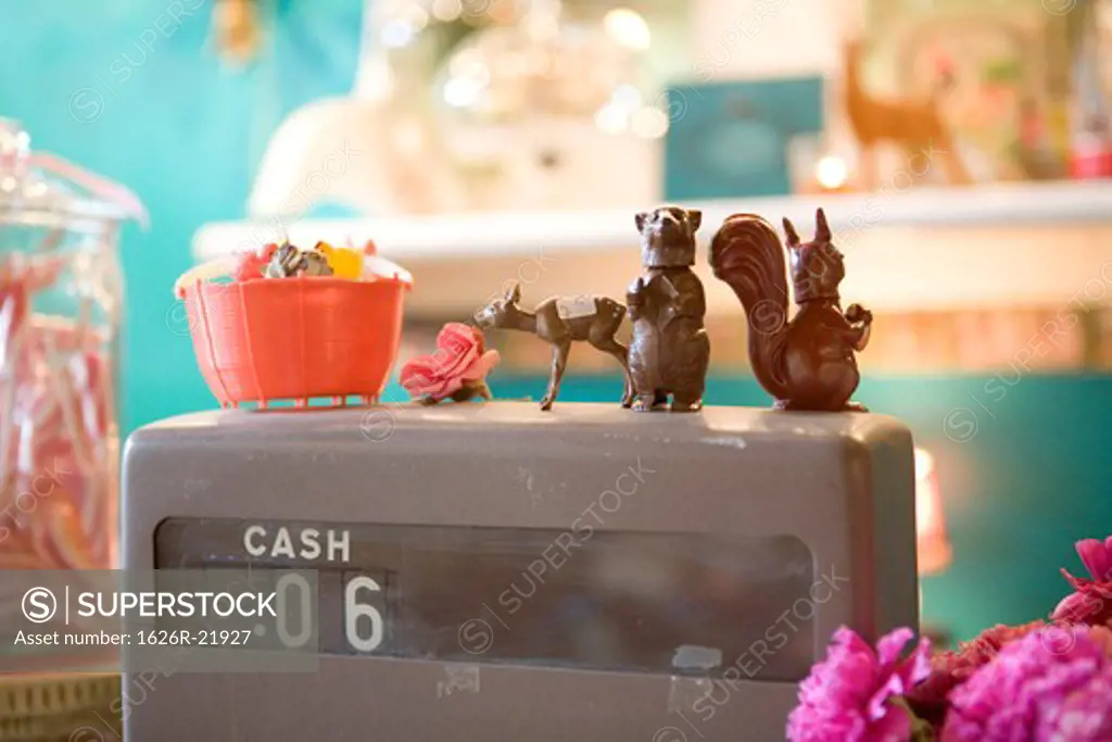 Plastic Figurines on an Old Cash Register