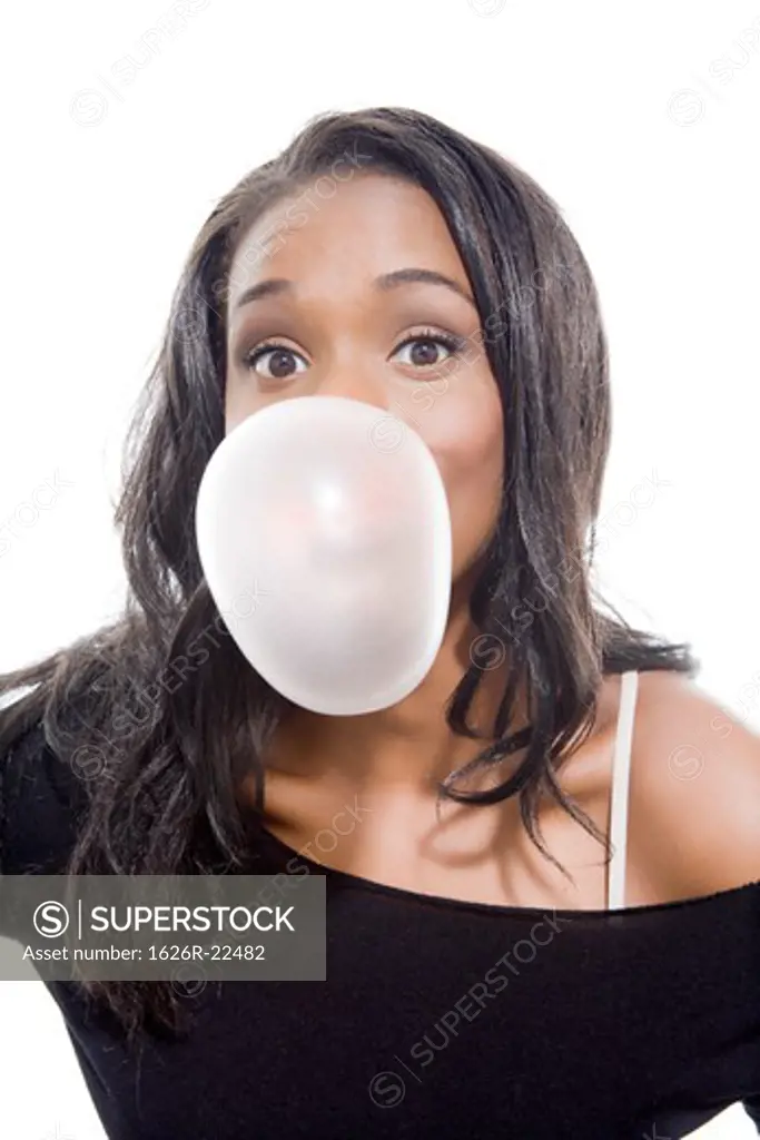 Attractive Young Woman Blowing Bubble Gum with Expectant Expression