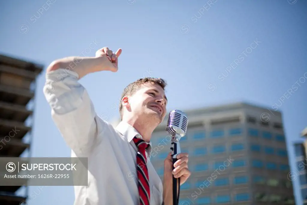Young politician making point in urban setting