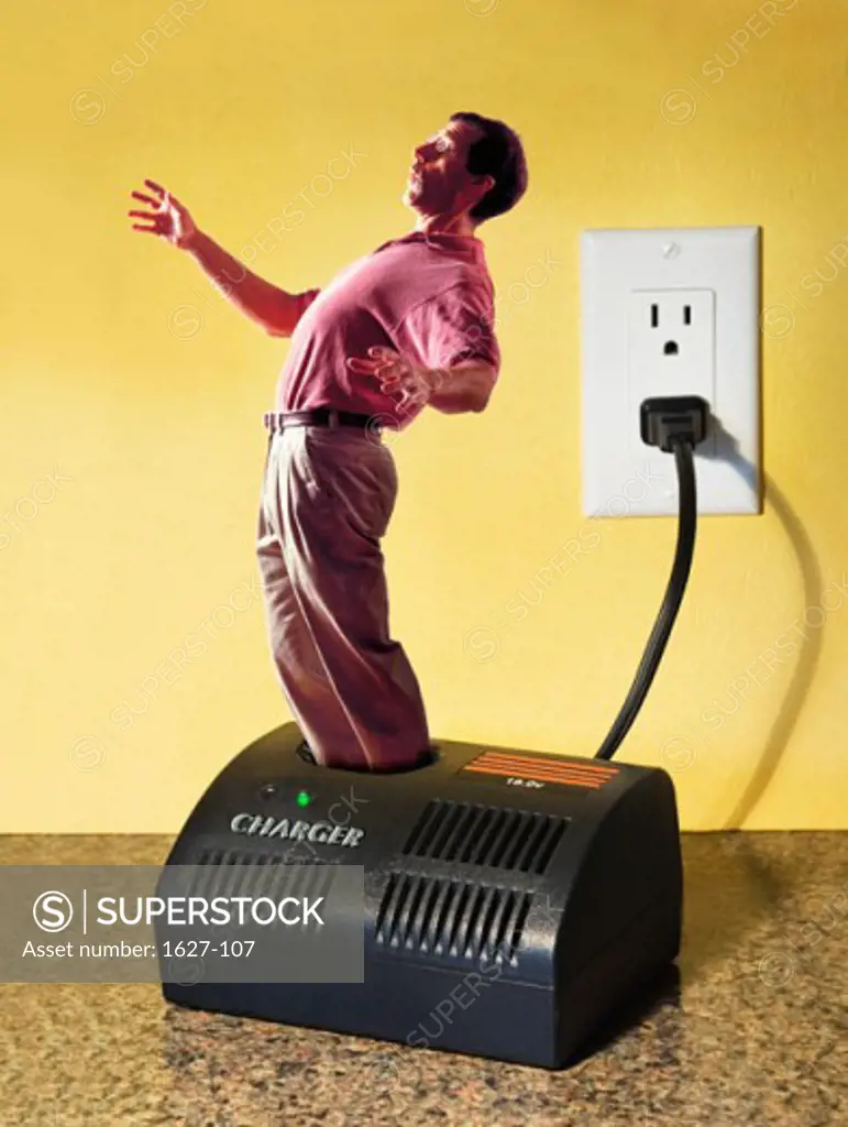 Side profile of a young man standing in a battery charger