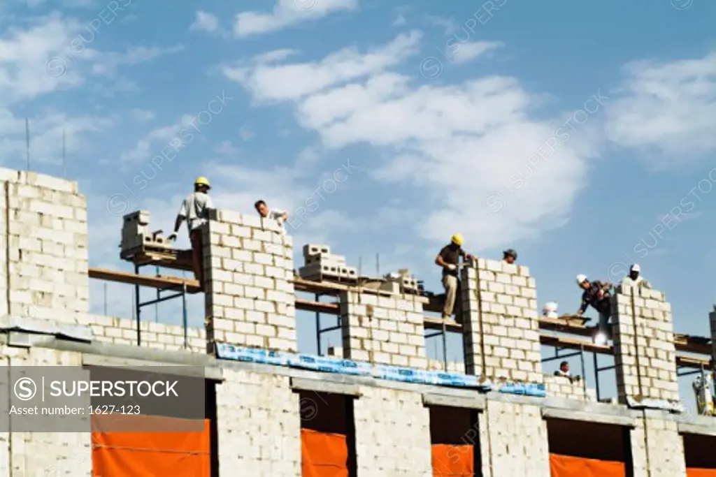 Low angle view of construction workers working at a construction site