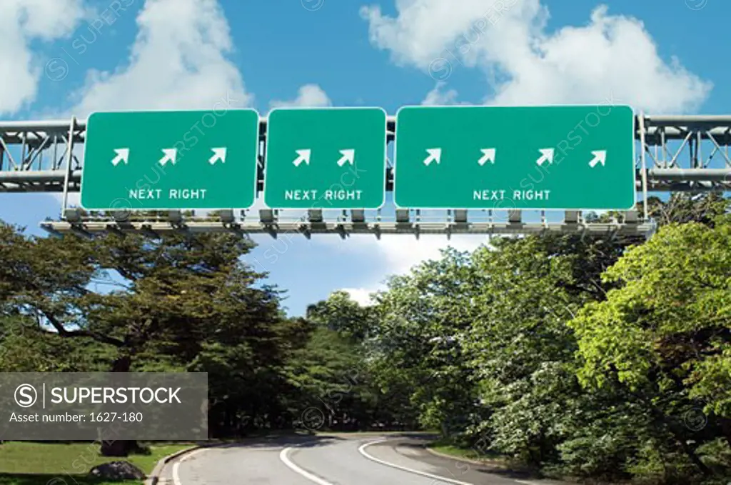 Low angle view of arrow signs on information boards