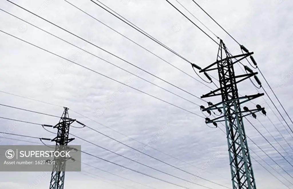 Low angle view of two electricity pylons
