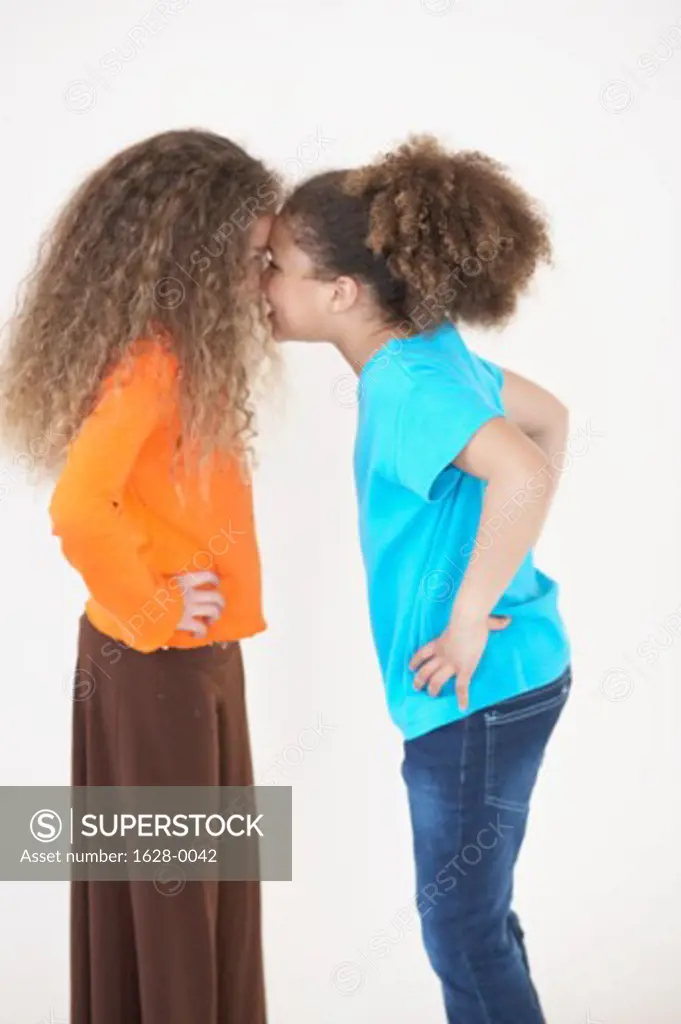 Side profile of two girls nuzzling