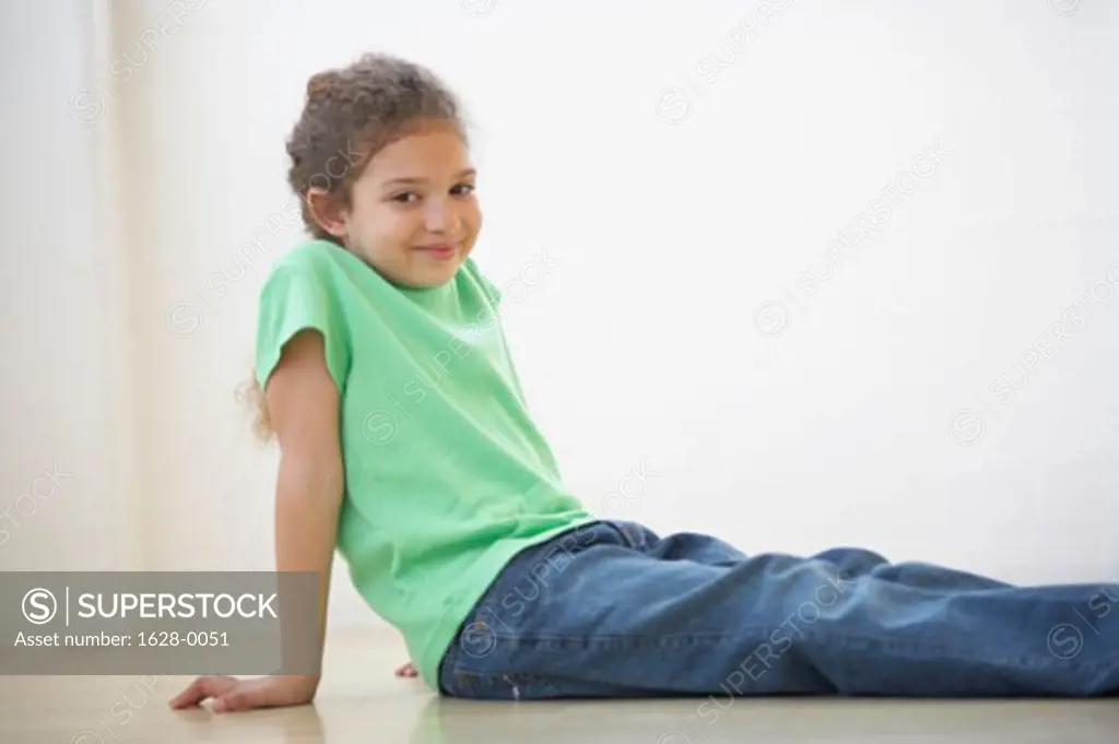 Portrait of a girl sitting on the floor