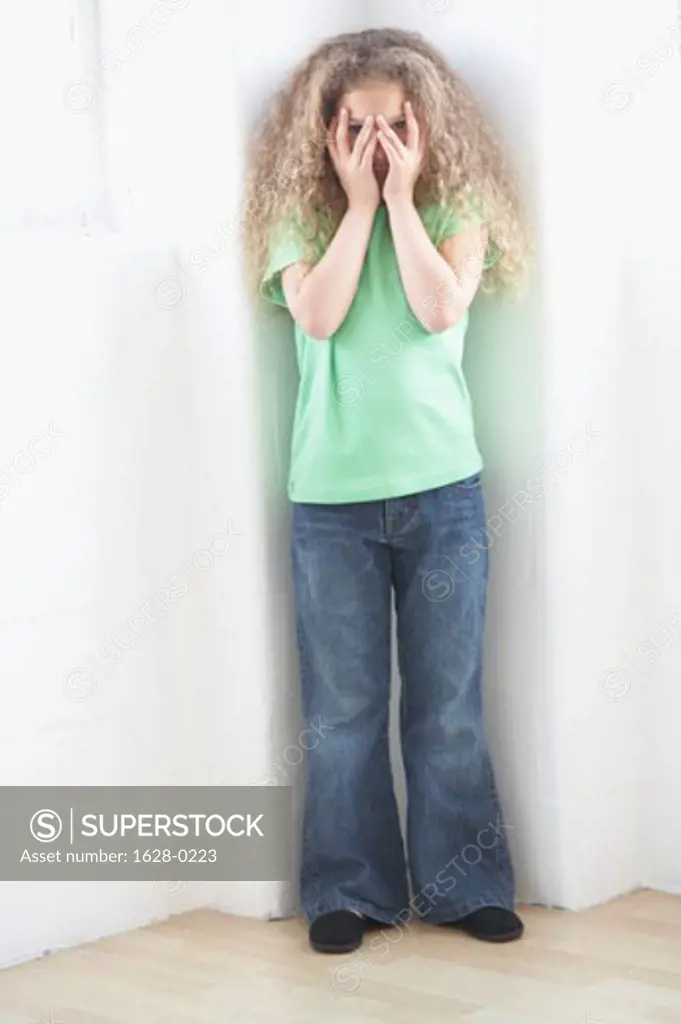 Girl hiding her face with her hands