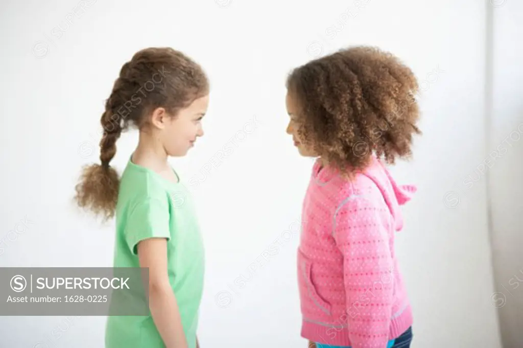 Side profile of two girls standing face to face