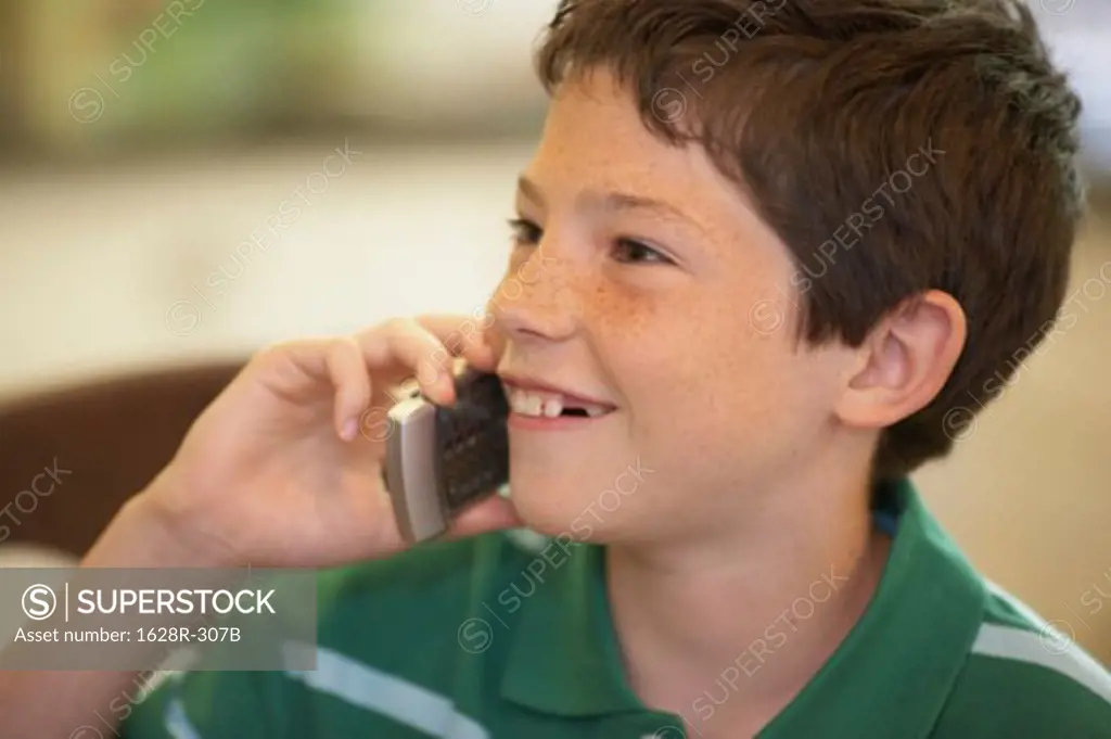 Close-up of a boy talking on a mobile phone