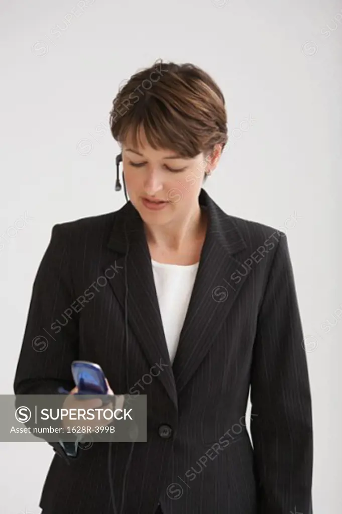 Close-up of a businesswoman talking on a mobile phone using a hands free device