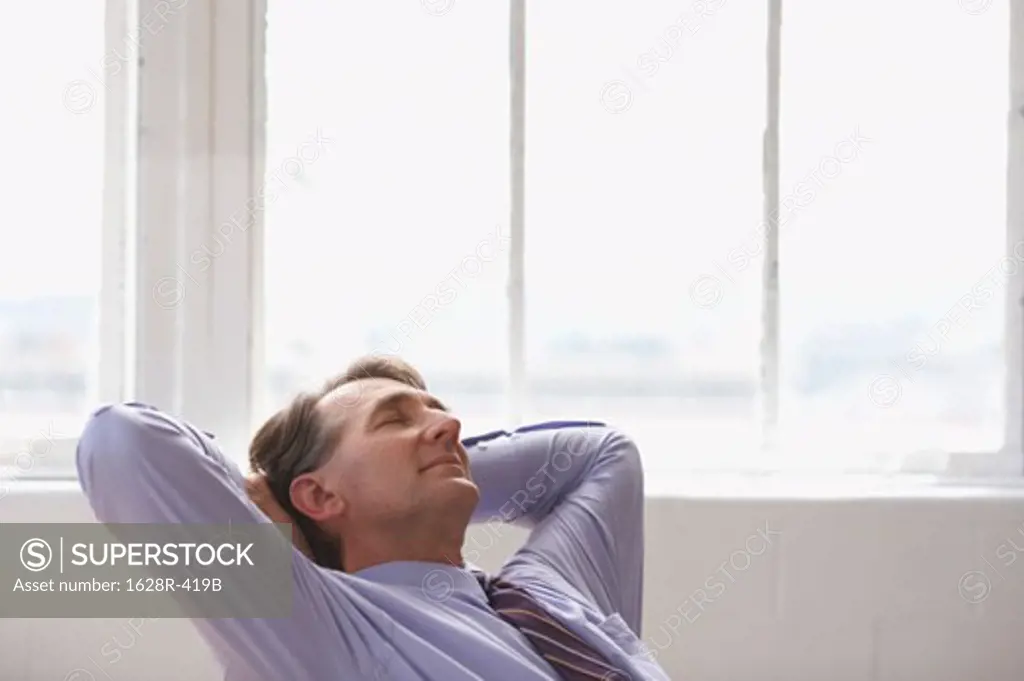 Businessman with his hands behind his head