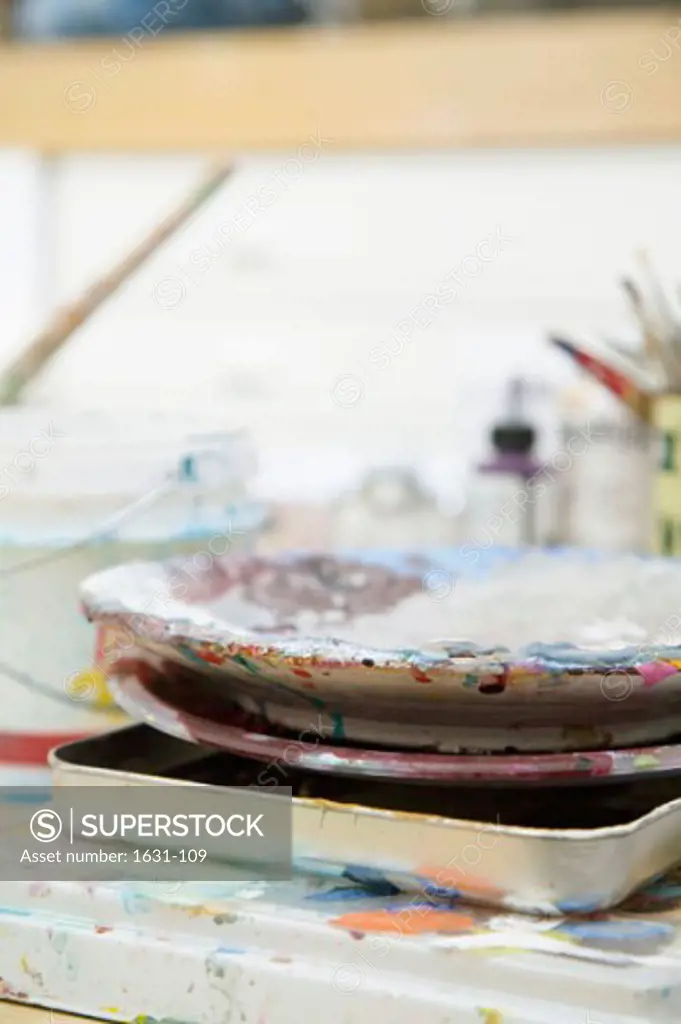 Close-up of a paint tray and paint bowls on a table