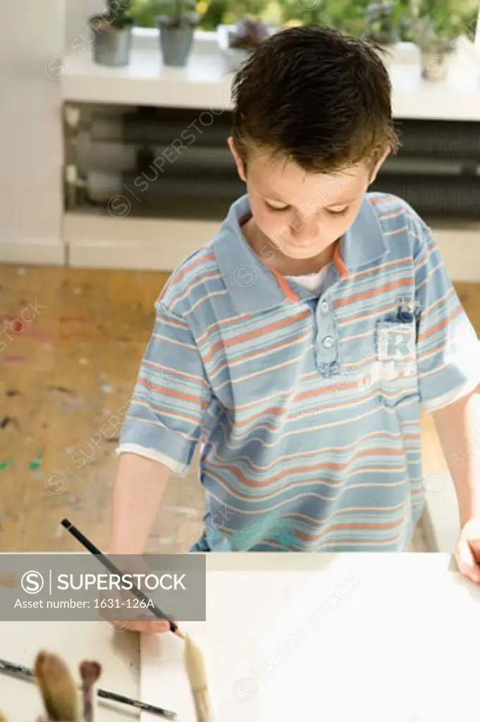 High angle view of a boy drawing on a sketch pad