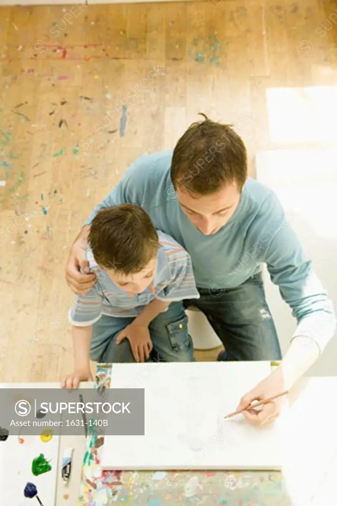 High angle view of a young man drawing with his son