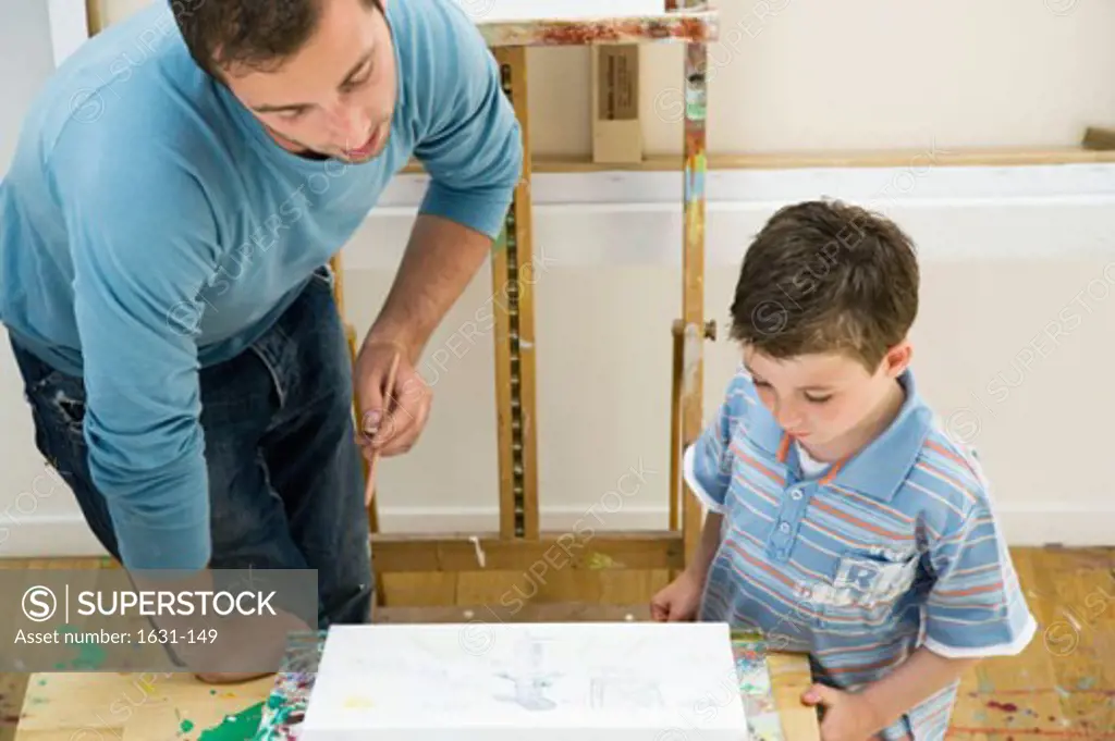 Close-up of a father drawing with his son