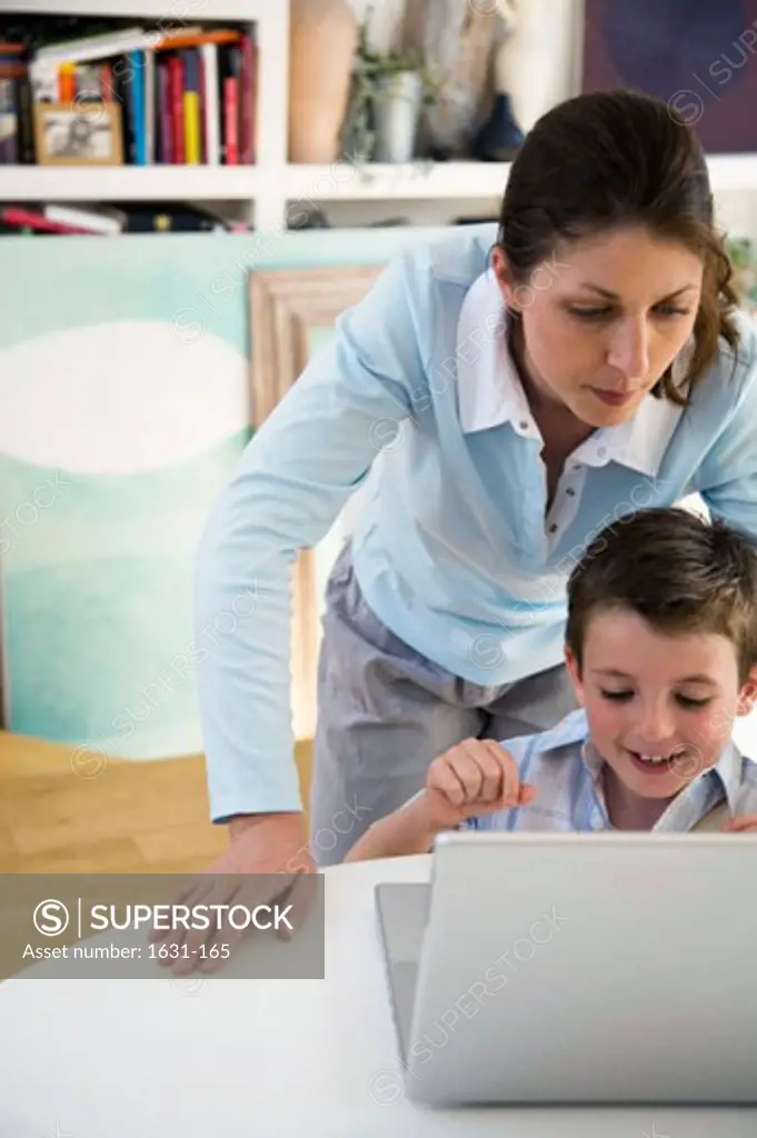 Young woman and her son using a laptop